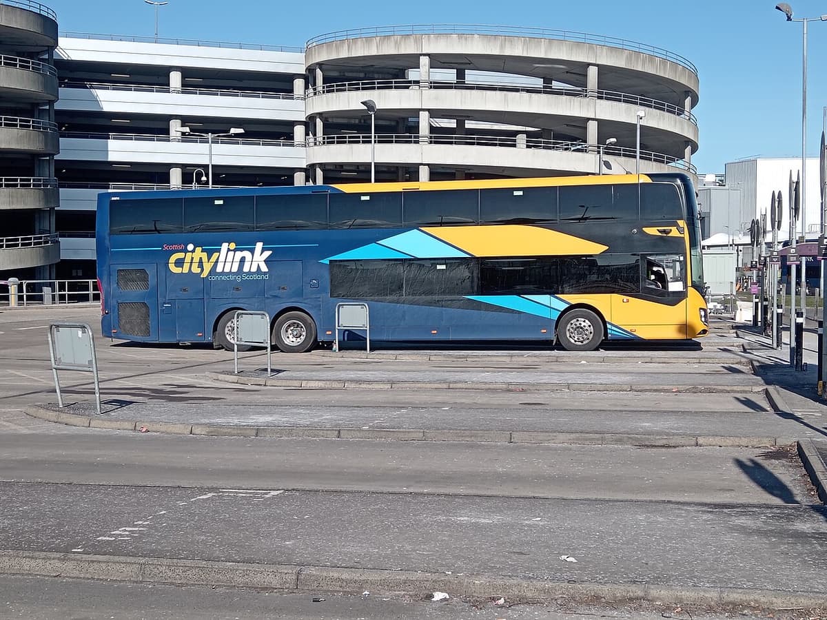 A blue and yellow Scottish Citylink double-deck coach