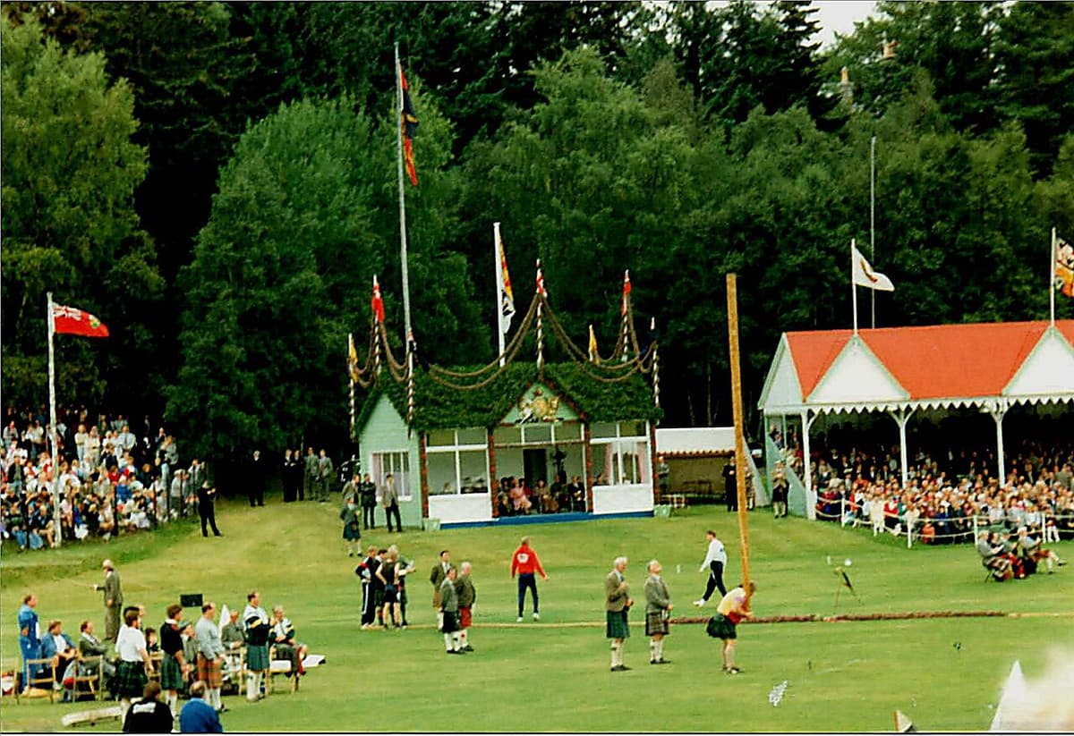 A competitor tossing the caber in front of the grandstand at the Braemar Gathering