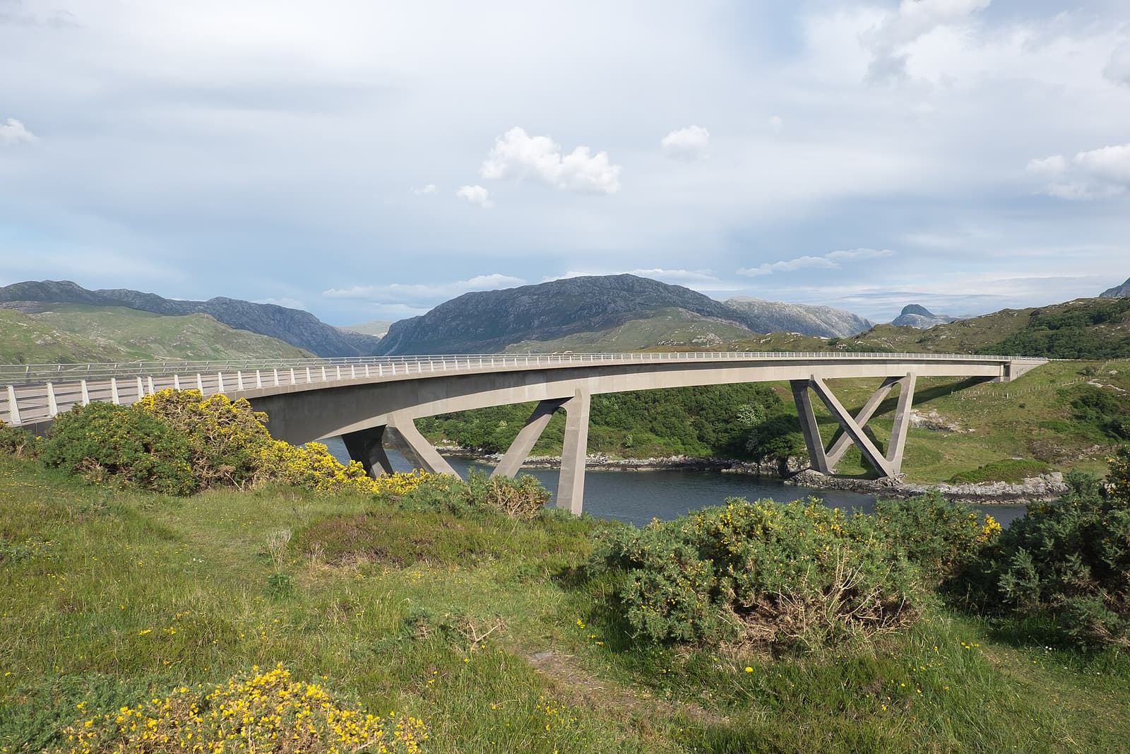 The curving concrete Kylesku Bridge crossing a sea loch in the north-west Highlands