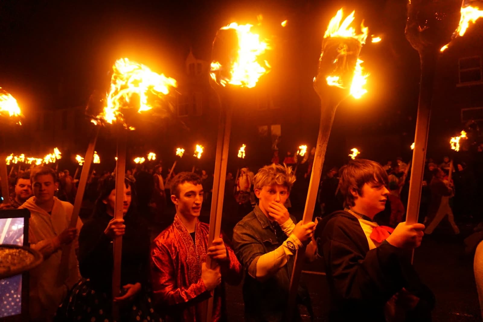 A crowd carrying flaming torches in the Up Helly Aa procession in Lerwick