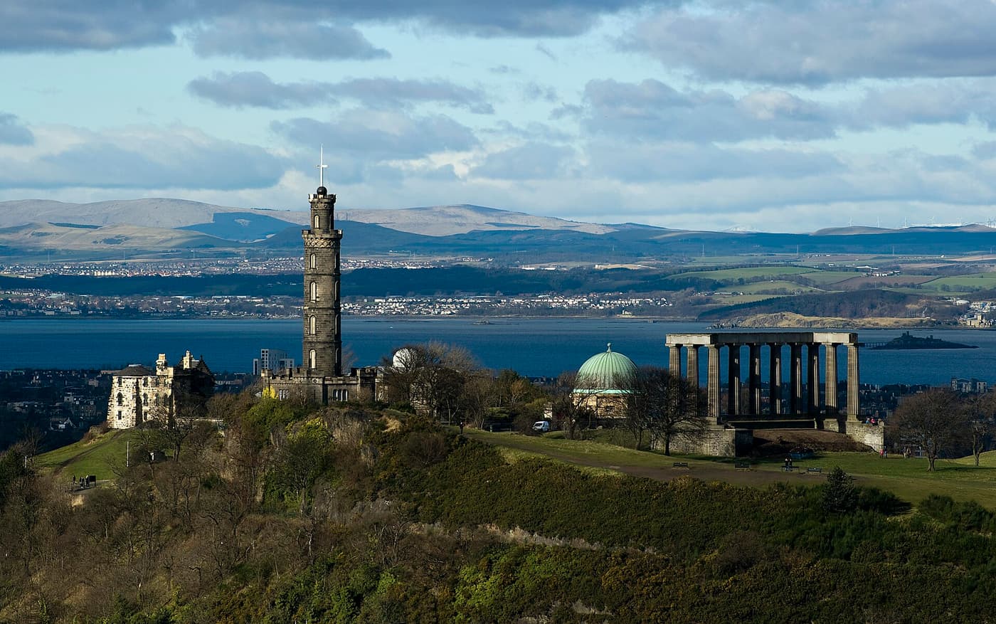 Calton Hill and its monuments with the Firth of Forth beyond