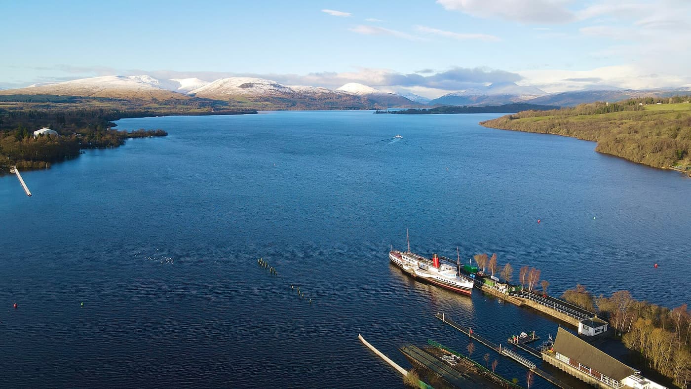 The paddle steamer Maid of the Loch at Balloch pier, with Loch Lomond stretching north