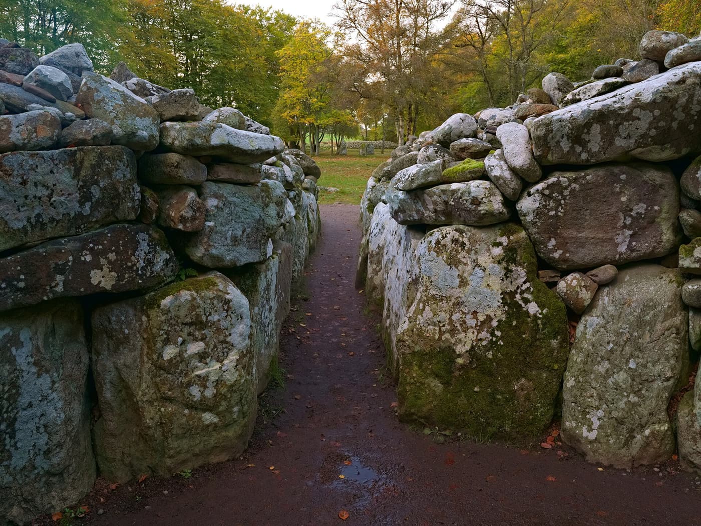 A passage between the stone walls of a Bronze Age cairn at Clava