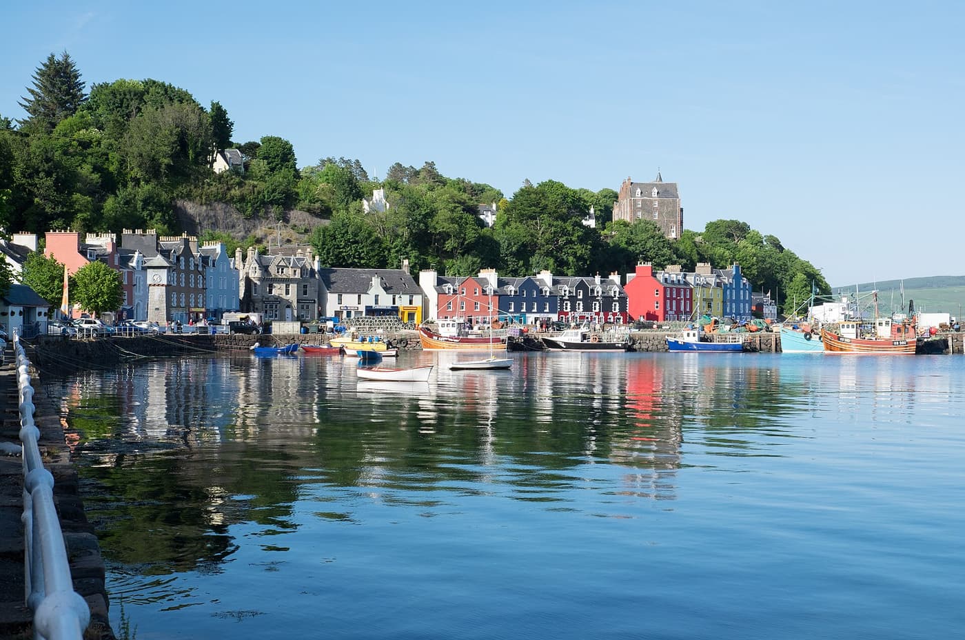 The brightly painted houses of Tobermory reflected in the harbour