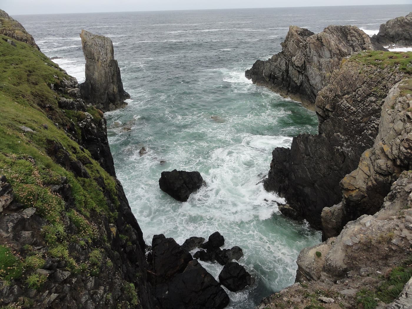 Waves breaking against the cliffs and sea stacks at the Butt of Lewis