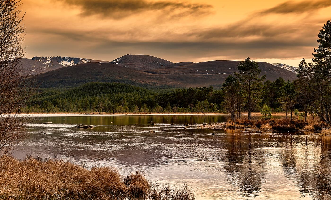 Loch Morlich at sunset with the Cairngorm mountains behind