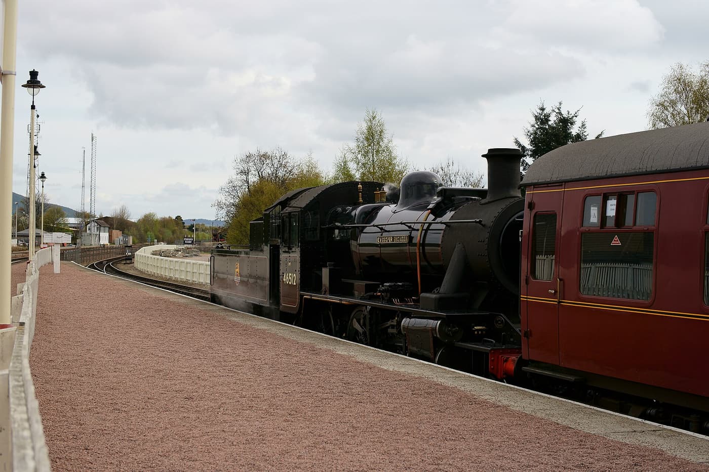 A steam locomotive of the Strathspey Railway at a station platform